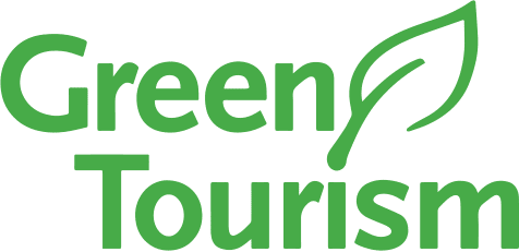 Logo with text Green Tourism and a leaf