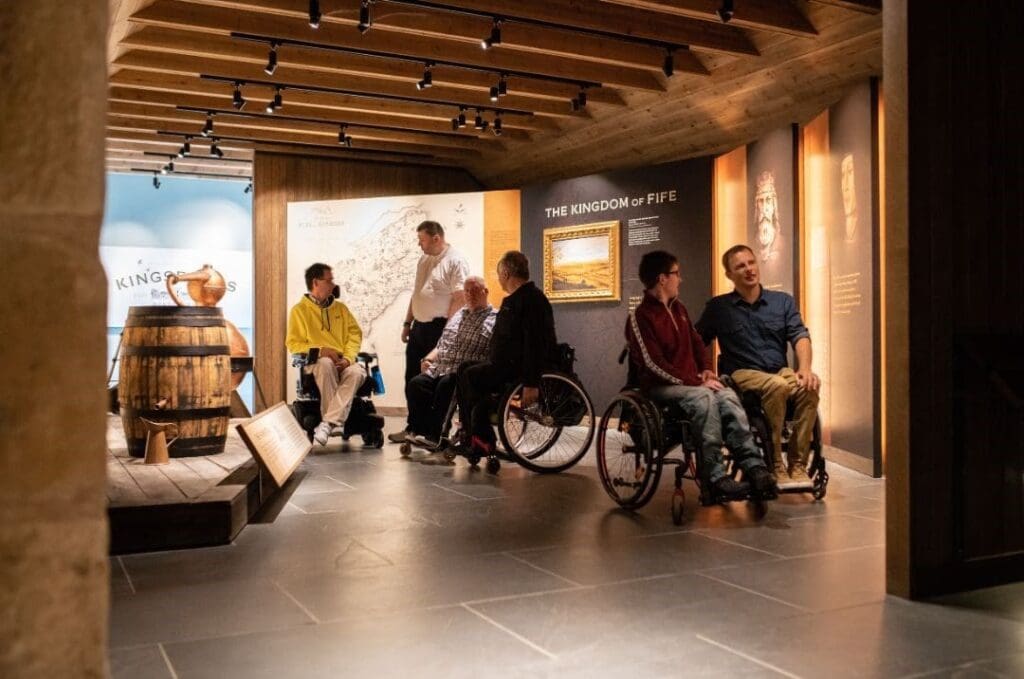Kingsbarns distillery visitor centre, 5 people in wheelchairs exploring the visitor attraction